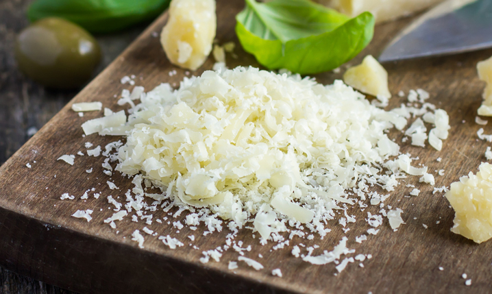 grated cotija cheese on a chopping board