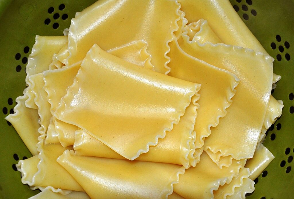 fresh raw uncooked lasagna pasta sheets in a collander