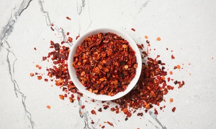 a bowl containing red pepper flakes