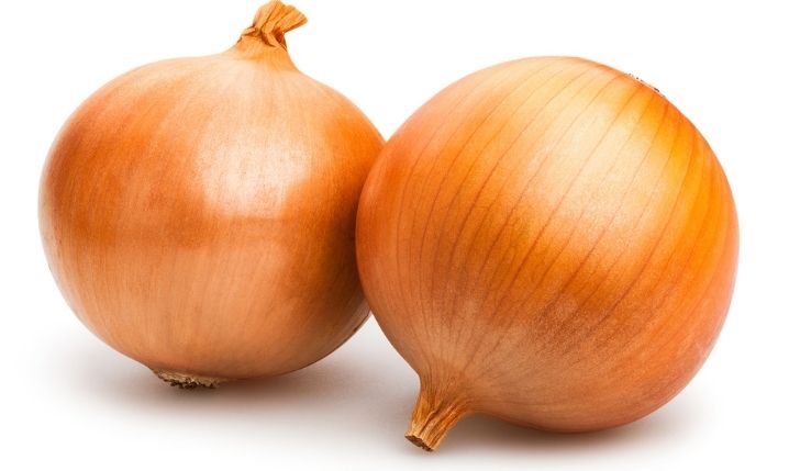 two large spanish onions with the skins still on
